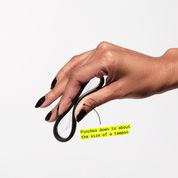 Hand pinching a folded menstrual disc with text showing size comparison to a tampon