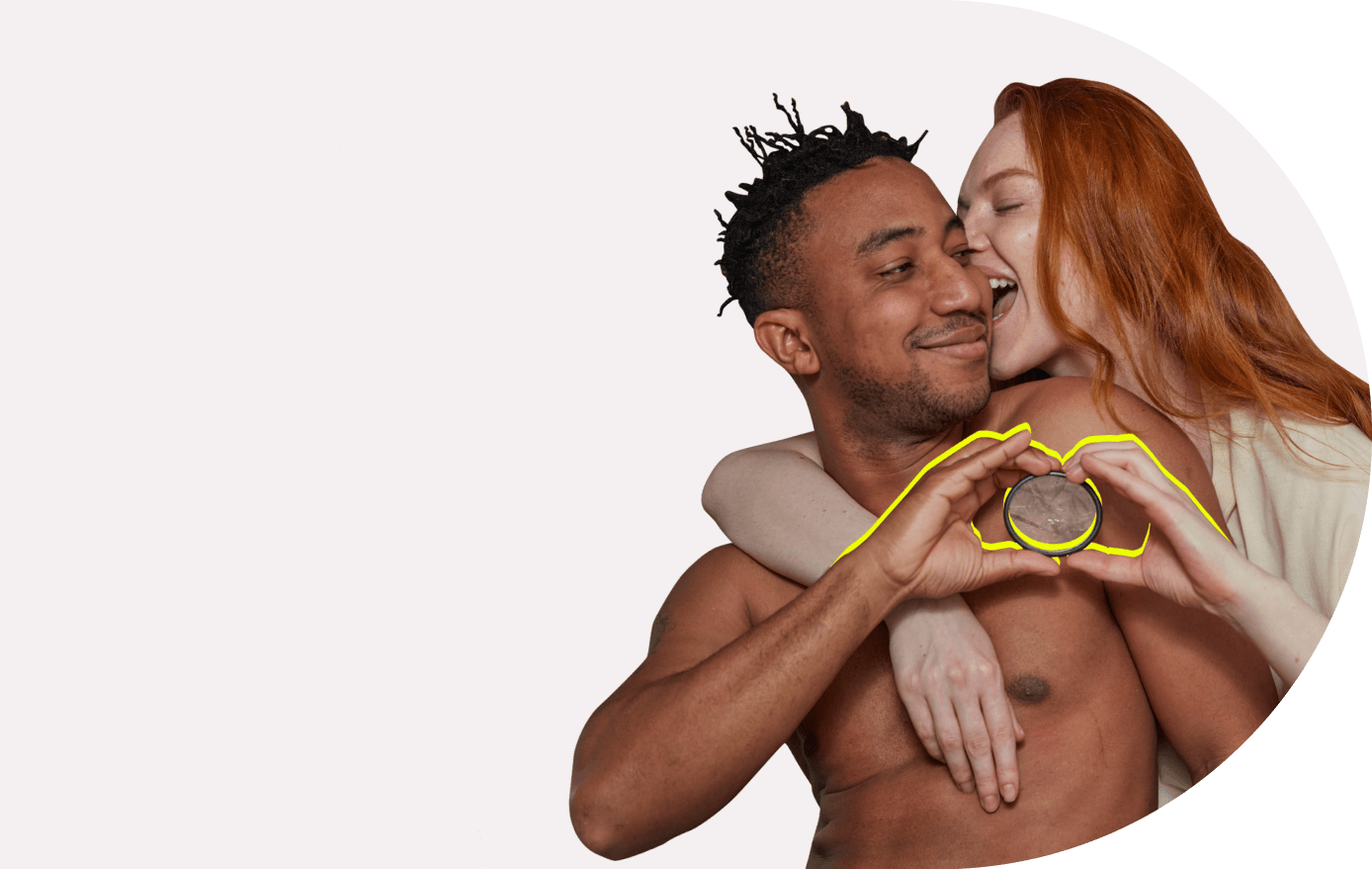 Couple embracing while holding a menstrual disc together in a heart-shaped hand gesture